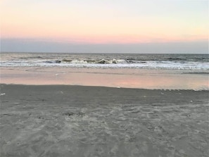 A beach with waves at the shore.