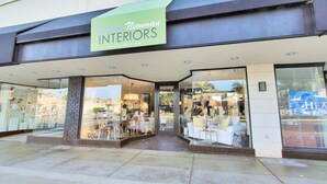A storefront with a sign for 'Jack & Newman Interiors'. - CDM Beach House (Newport Beach)