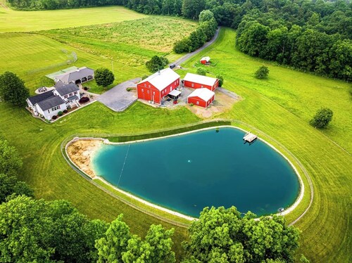 A luxury farm stay with something special for everyone in your group! Volleyball, baseball, pickleball, outdoor kitchen with pavilion, a private pond and dock for swimming, and so much more!