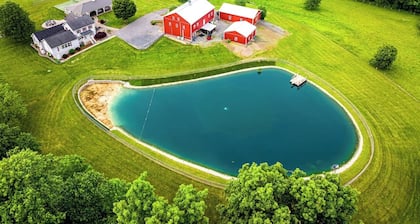A luxury farm stay with something special for everyone in your group! Volleyball, baseball, pickleball, outdoor kitchen with pavilion, a private pond and dock for swimming, and so much more!