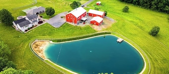 A luxury farm stay with something special for everyone in your group! Volleyball, baseball, pickleball, outdoor kitchen with pavilion, a private pond and dock for swimming, and so much more!
