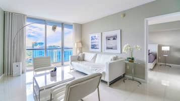 Luxury Condo, 1 Bedroom, City View | Living area | 50-inch Smart TV with cable channels
