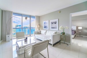Luxury Condo, 1 Bedroom, City View | Living area | 50-inch Smart TV with cable channels