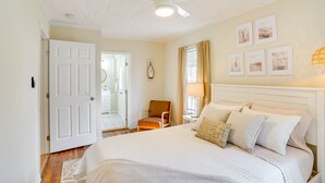 A bedroom with a bed, a chair, a ceiling fan, and framed pictures on the wall. - Lake Wales Vacation Rental w/ Screened-In Porch! (Lake Wales)