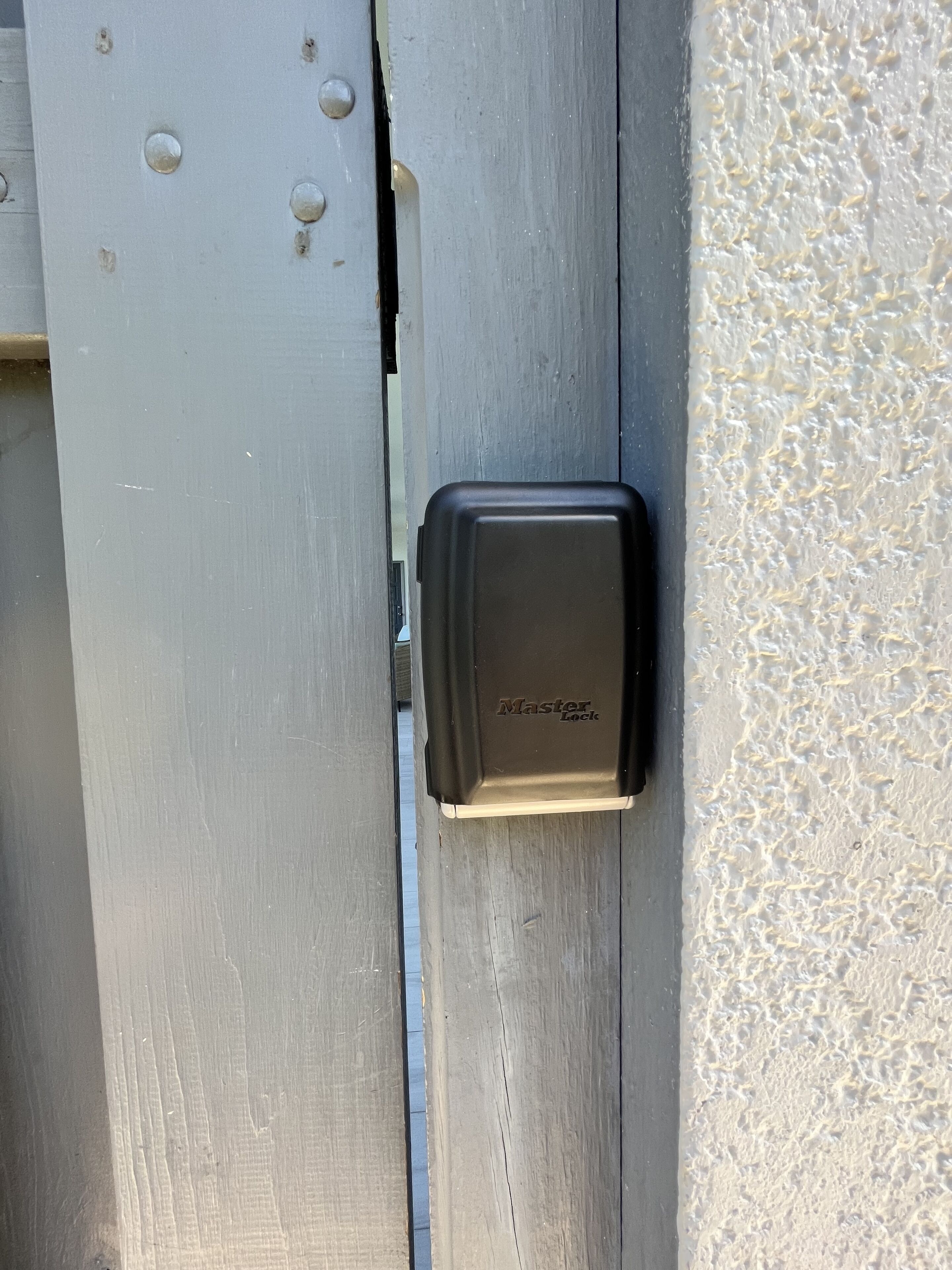 A metal door with a black electronic lock labeled "Master Lock".
