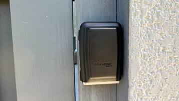 A metal door with a black electronic lock labeled "Master Lock".