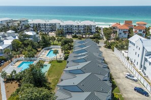 A coastal hotel with multiple buildings, a swimming pool, and a view of the ocean. - Palms North 3b - Sea La Vie - Deeded Beach Access! (Santa Rosa Beach)