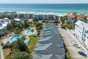 A coastal hotel with multiple buildings, a swimming pool, and a view of the ocean. - Deeded Beach Access and Community Pool (Santa Rosa Beach)