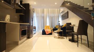 Deluxe Duplex | Living area | Flat-screen TV