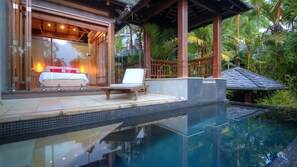 A modern pool area with a lounge chair and a bed visible through a glass door. - 2B Far Pavilions Port Douglas (Port Douglas)