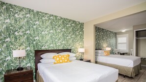 A hotel room with two beds, a wooden nightstand, and a mirror. - The Local - St. Augustine (St. Augustine)