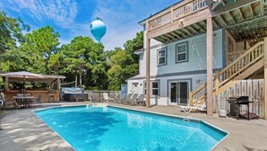 A backyard with a swimming pool, a hot tub, and a covered patio area. - Castaway: Private Pool, Hot Tub & Ocean Breeze (Corolla)