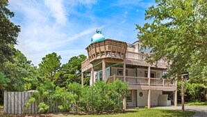 A two-story house with a blue dome on the roof, a wooden deck, and a fenced yard. - Castaway: Private Pool, Hot Tub & Ocean Breeze (Corolla)