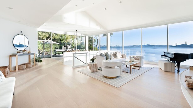 A spacious living room with a piano, large windows offering a view of the water, and a modern interior design. - Stunning Panoramic views of SF, Bay/GG Bridge, Sausalito, Mt. Tam in  Belvedere (Belvedere)