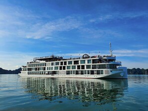 A large, multi-deck river cruise ship named 'Indochine' with multiple balconies and a prominent observation deck.