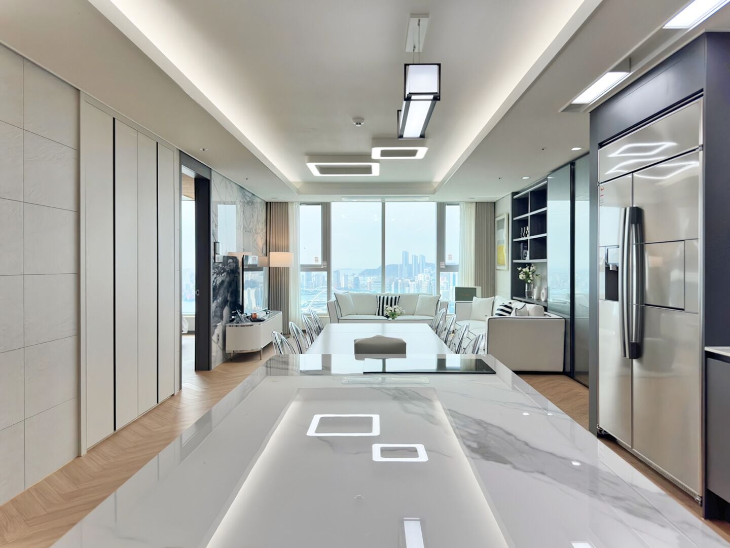 A modern kitchen with a marble countertop, built-in appliances, and a city view.