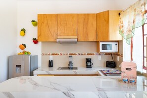 Fridge, microwave, coffee/tea maker, cookware/dishes/utensils