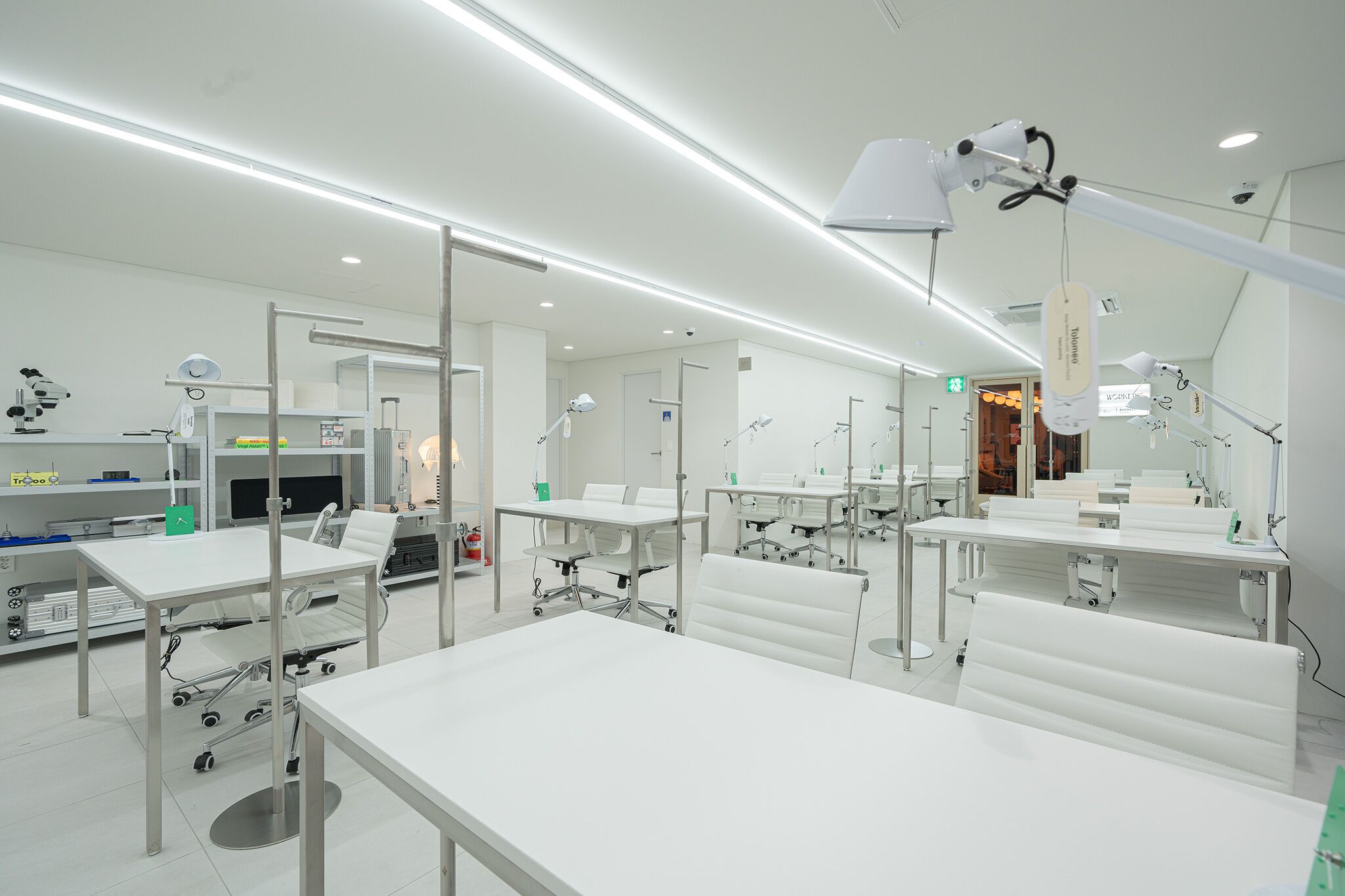 Un entorno clínico con mesas y sillas blancas, además de equipo médico.