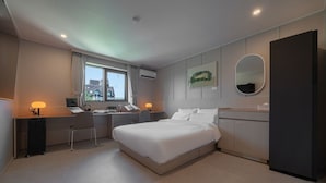 A modern hotel room with a bed, desk, chair, and a large mirror. - Workers Hotel Ansan by Anook (Ansan)