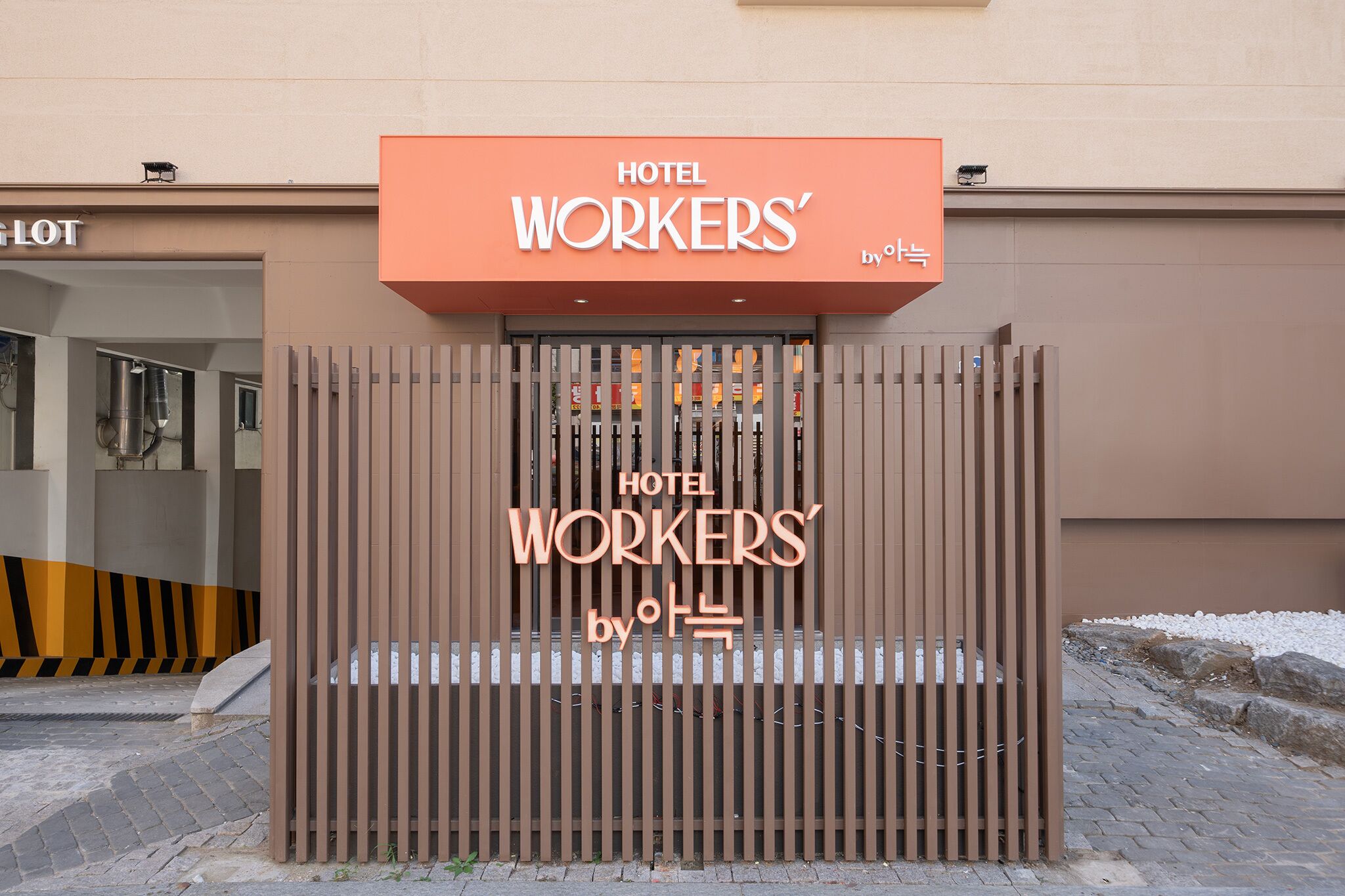 A hotel entrance with a sign reading "HOTEL WORKERS' by OTB".