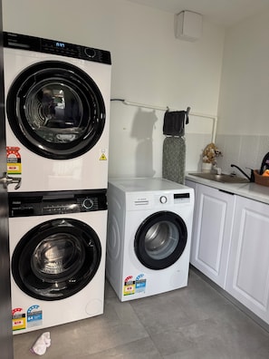 Convenient laundry facilities feature two front-loading washing machines with energy and water efficiency ratings.