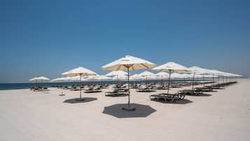 Private beach, white sand, sun loungers, beach umbrellas