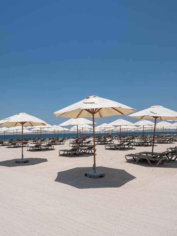 Private beach, white sand, sun loungers, beach umbrellas
