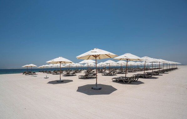 Private beach, white sand, sun loungers, beach umbrellas