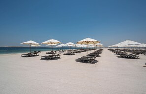 Private beach, white sand, sun loungers, beach umbrellas