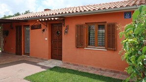 A two-story building with a tiled roof, a wooden door, and a window with shutters. - Vacation home Milena by Interhome (Barban)