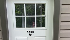 A white door with a window and the text 'Golden Spa' above it. - Romantic Couples Getaway - Sauna, Hot Tub, Private Beach access, Hiking trails (Lambton Shores)