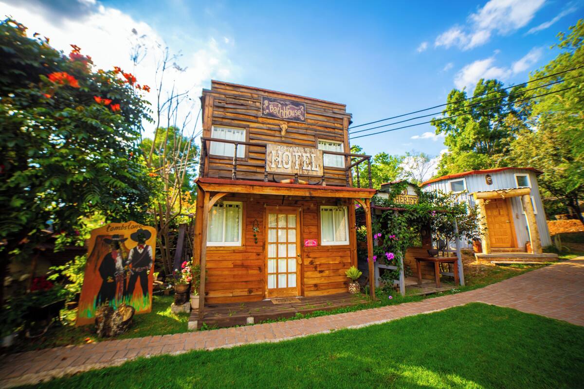 A wooden two-story building with a sign that reads "Hotel."