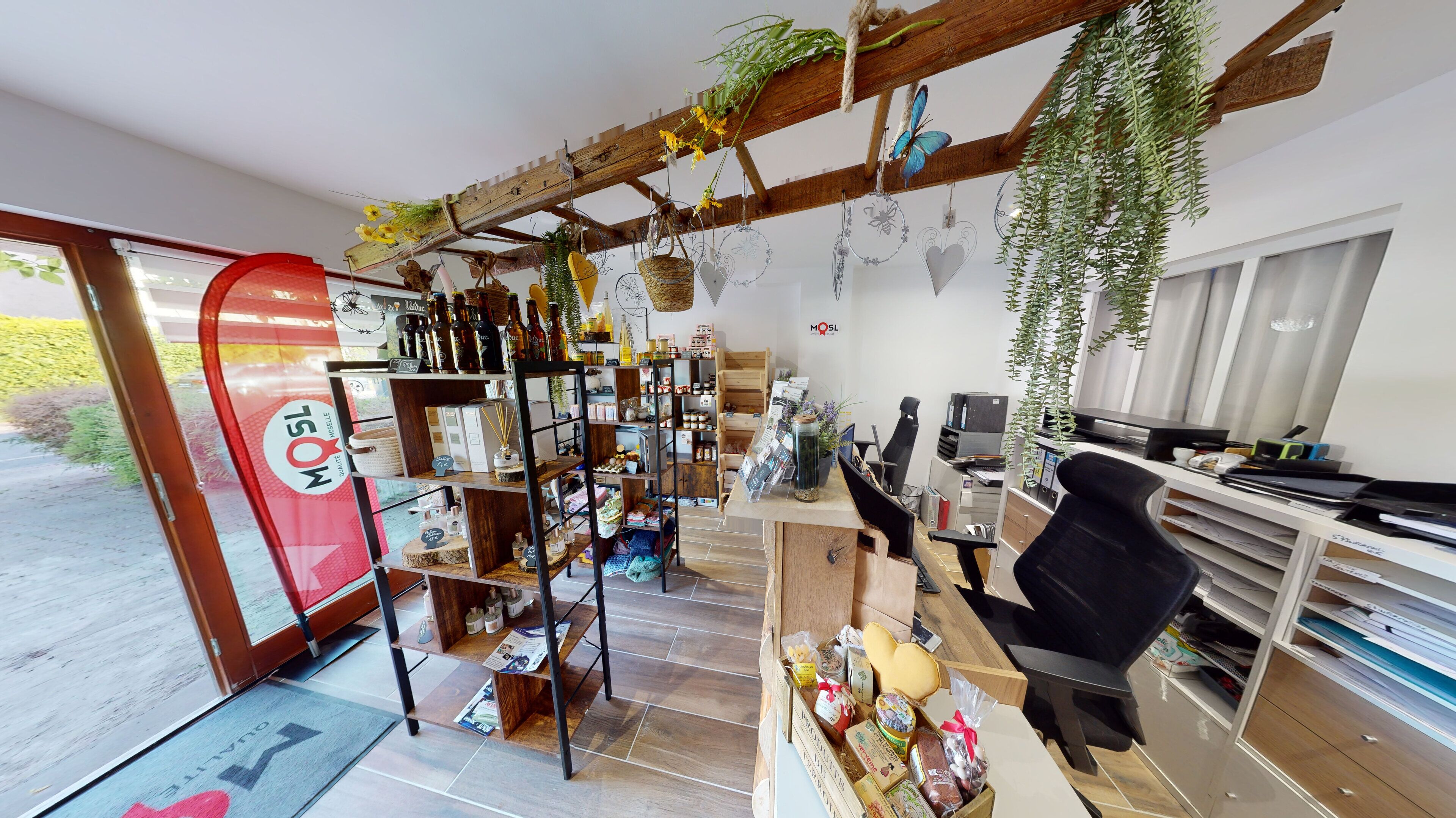 A cozy interior with wooden shelves, a desk, and hanging plants.