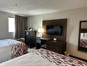 A hotel room with two beds, a desk with a TV, a microwave, and a chair. - Red Roof Inn Charleston - Dunbar (Dunbar)