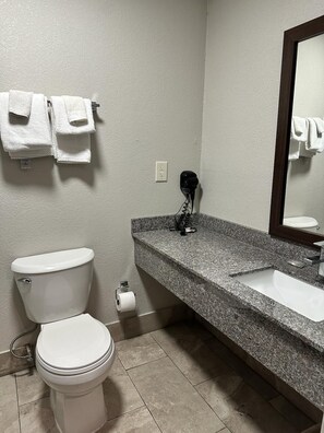 A bathroom with a toilet, sink, and towel rack. - Red Roof Inn Charleston - Dunbar (Dunbar)