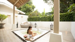 A spa area with a hot tub, seating, and a tray of amenities. - Villa ALANNA (Chiang Mai)