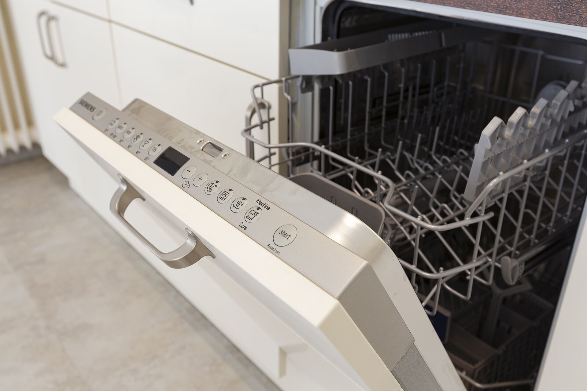 A dishwasher with a control panel and a rack of dishes inside.