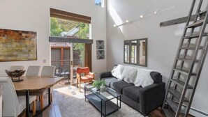 A modern living room with a dining area, a sofa, and a ladder. - Awesome Views; Ski In/Out & lift is 100 steps from the Door (Telluride)