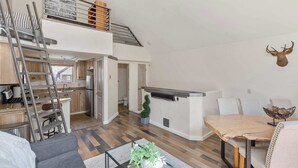 A modern loft apartment with a loft bed, kitchen, dining area, and a staircase. - Awesome Views; Ski In/Out & lift is 100 steps from the Door (Telluride)