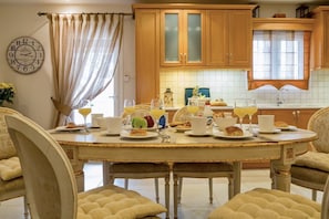 Enjoy meals in this stylish dining area with a round table and comfortable chairs.