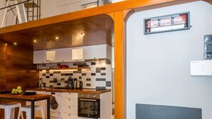 Et moderne køkken med en træø, lyse skabe og et ternet backsplash.