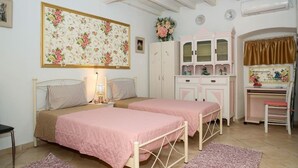 A bedroom with two beds, a dresser, a desk, and a chair. - Conte Studio - located in the heart of Corfu Old town (Kerkira)