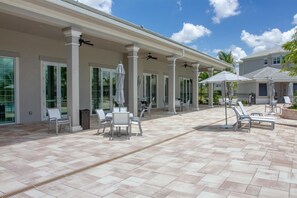 Relax in style on this spacious patio, complete with comfortable seating and ceiling fans.