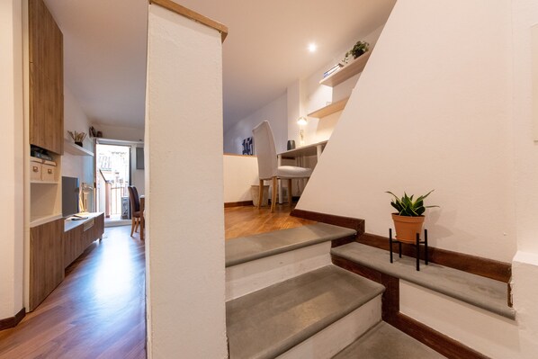 A staircase with a potted plant on the landing.
