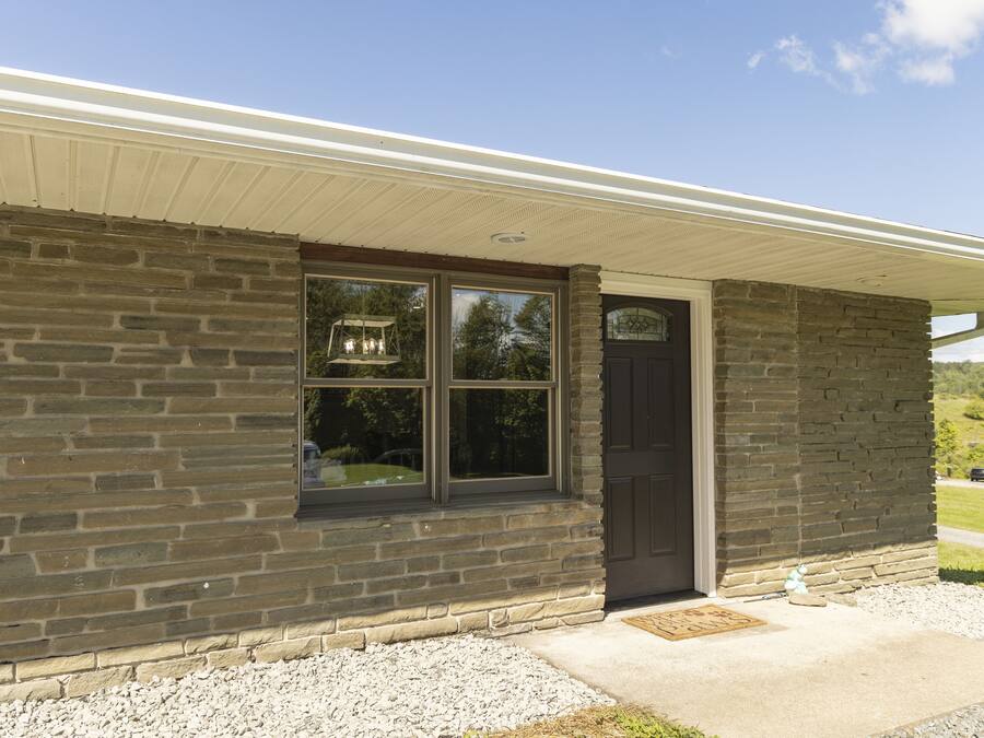 A stone building with a dark door and windows.