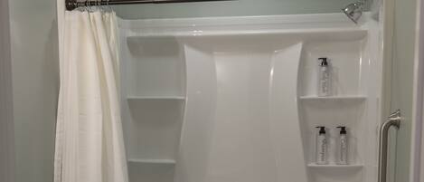A bathroom with a bathtub, toilet, and a shower curtain.