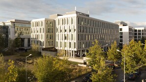 A modern building complex with multiple floors, large windows, and a flat roof. - Villa Doria  (Luxembourg City)