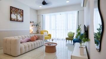 A modern living room with a sofa, coffee table, and chairs.
