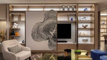 Una sala de estar moderna con un sofá modular, una mesa de centro y un televisor de pantalla plana.
