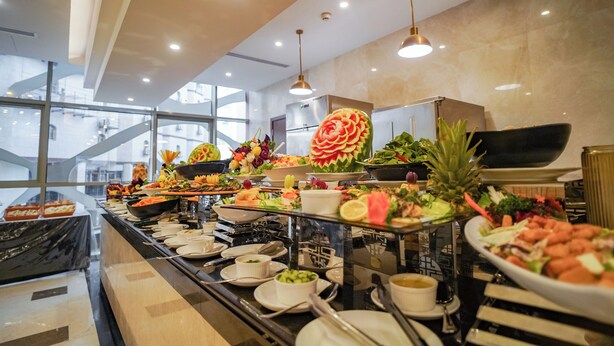 Un bufé con diversos platos y un gran centro de mesa decorativo.